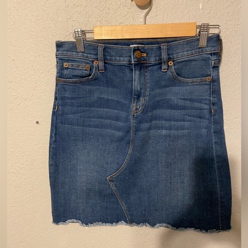 J Crew medium wash, distressed denim blue jean skirt. Women’s size 4